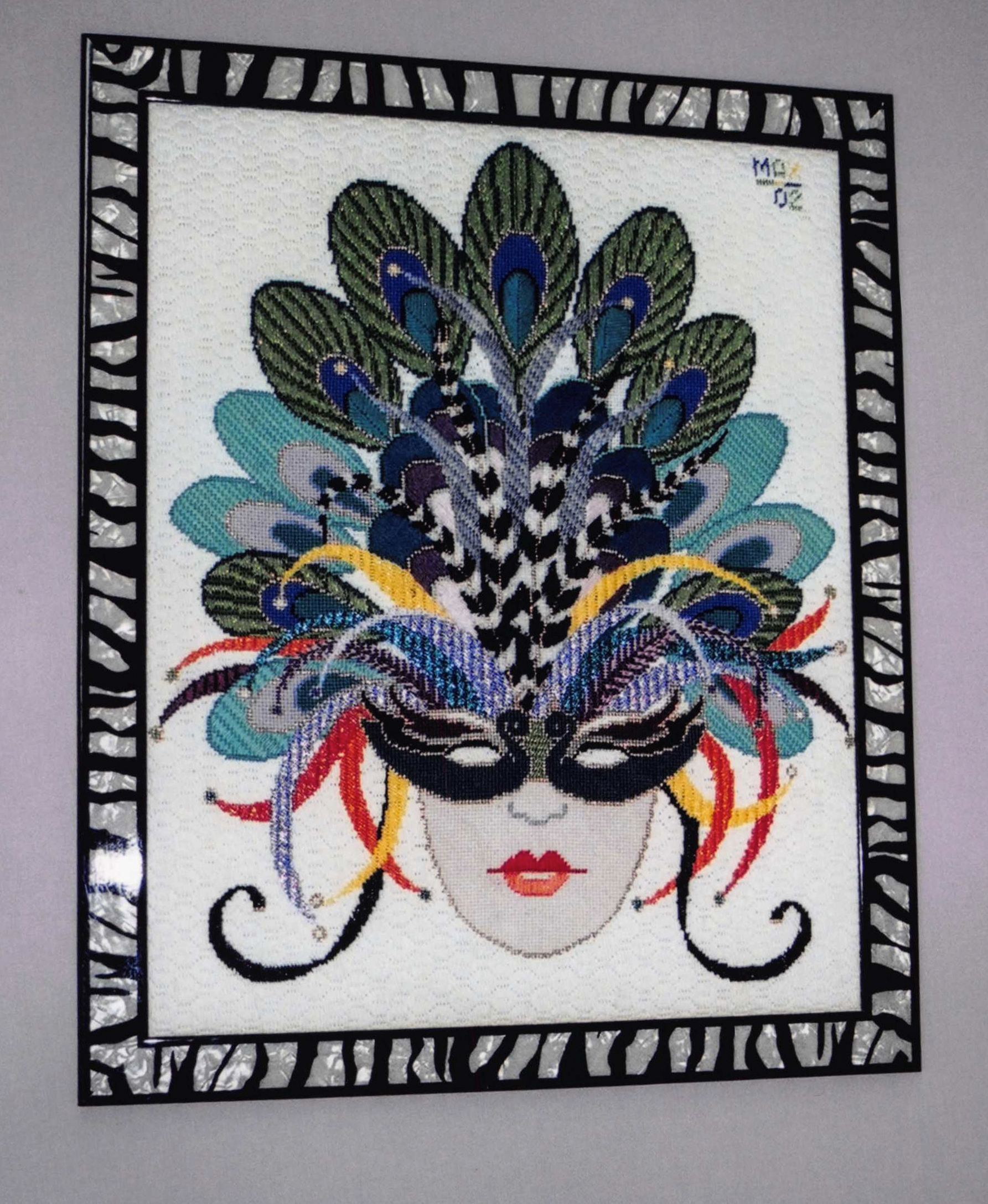 Framed needlepoint mask with peacock feathers and zebra stripes and zebra striped frame